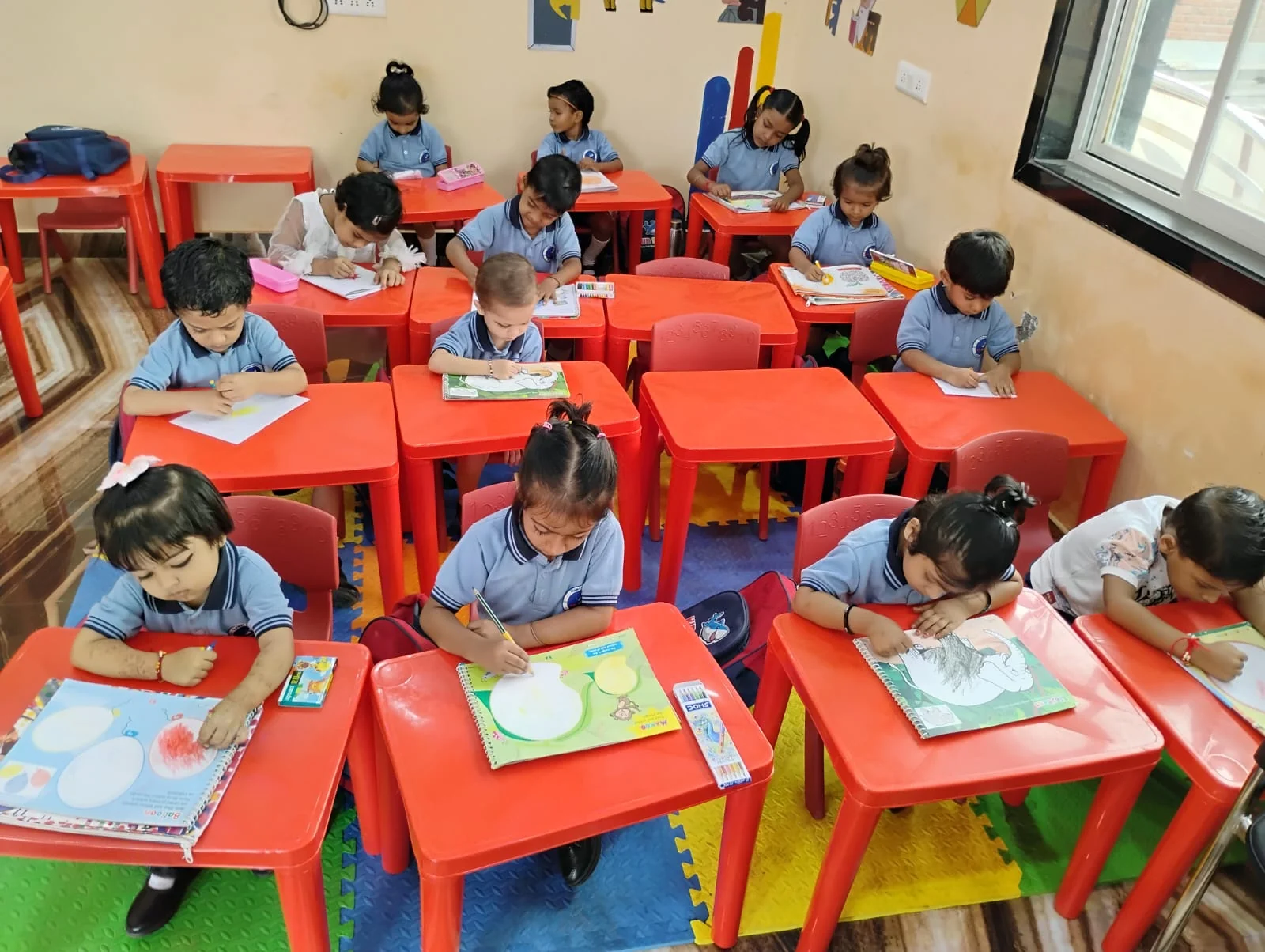 Children concentrating on classroom activities at their desks